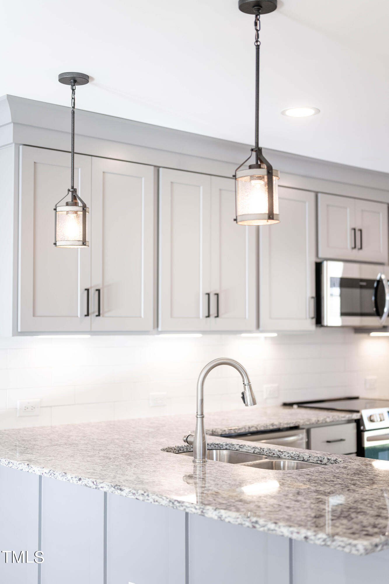 120 Jupiter Drive Dunn, NC 28334 - Photo 25 of 40 a kitchen with stainless steel appliances granite countertop a sink a stove and a wooden floor