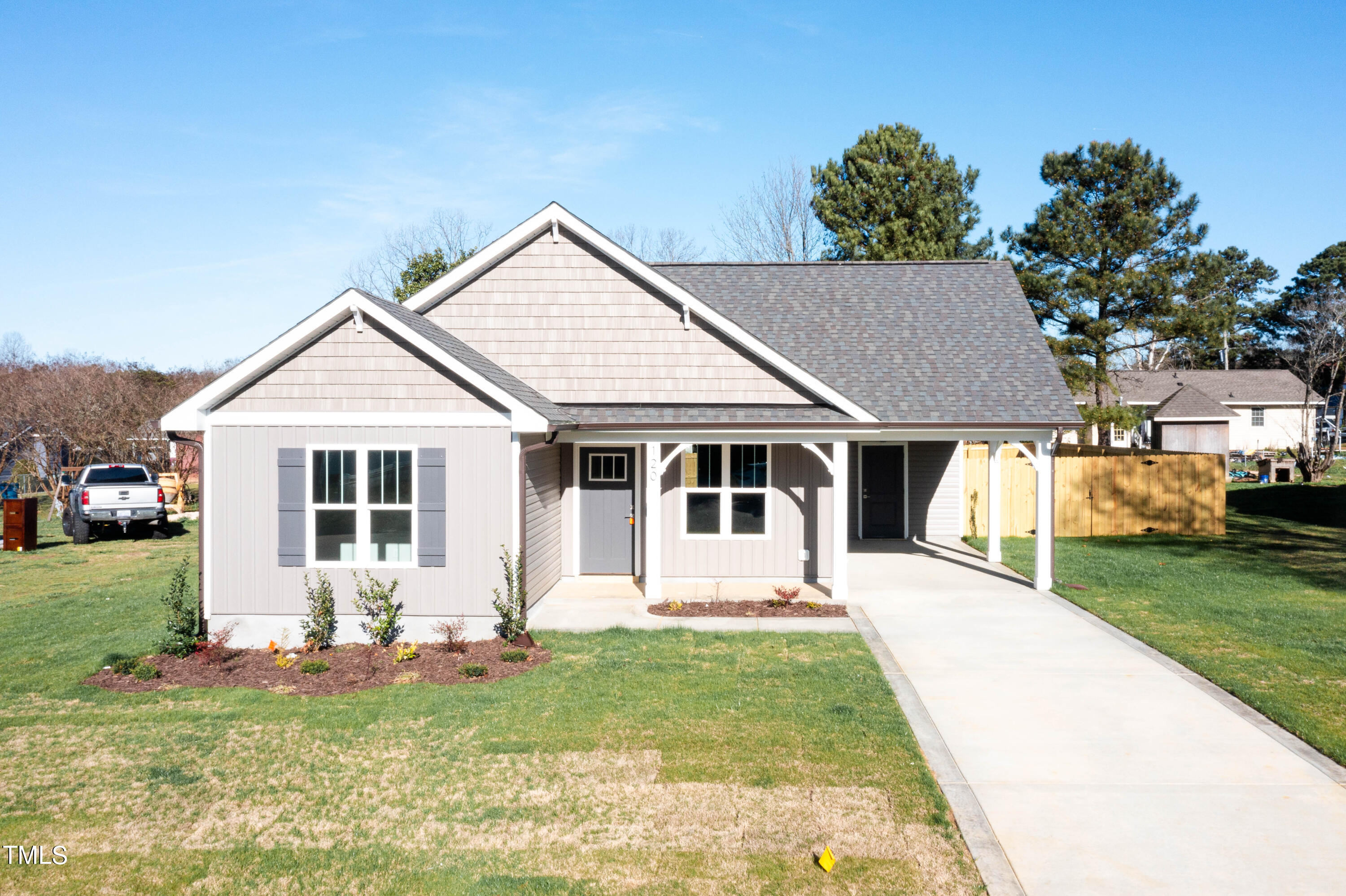 120 Jupiter Drive Dunn, NC 28334 - Photo 33 of 40 a front view of a house with a yard table and chairs