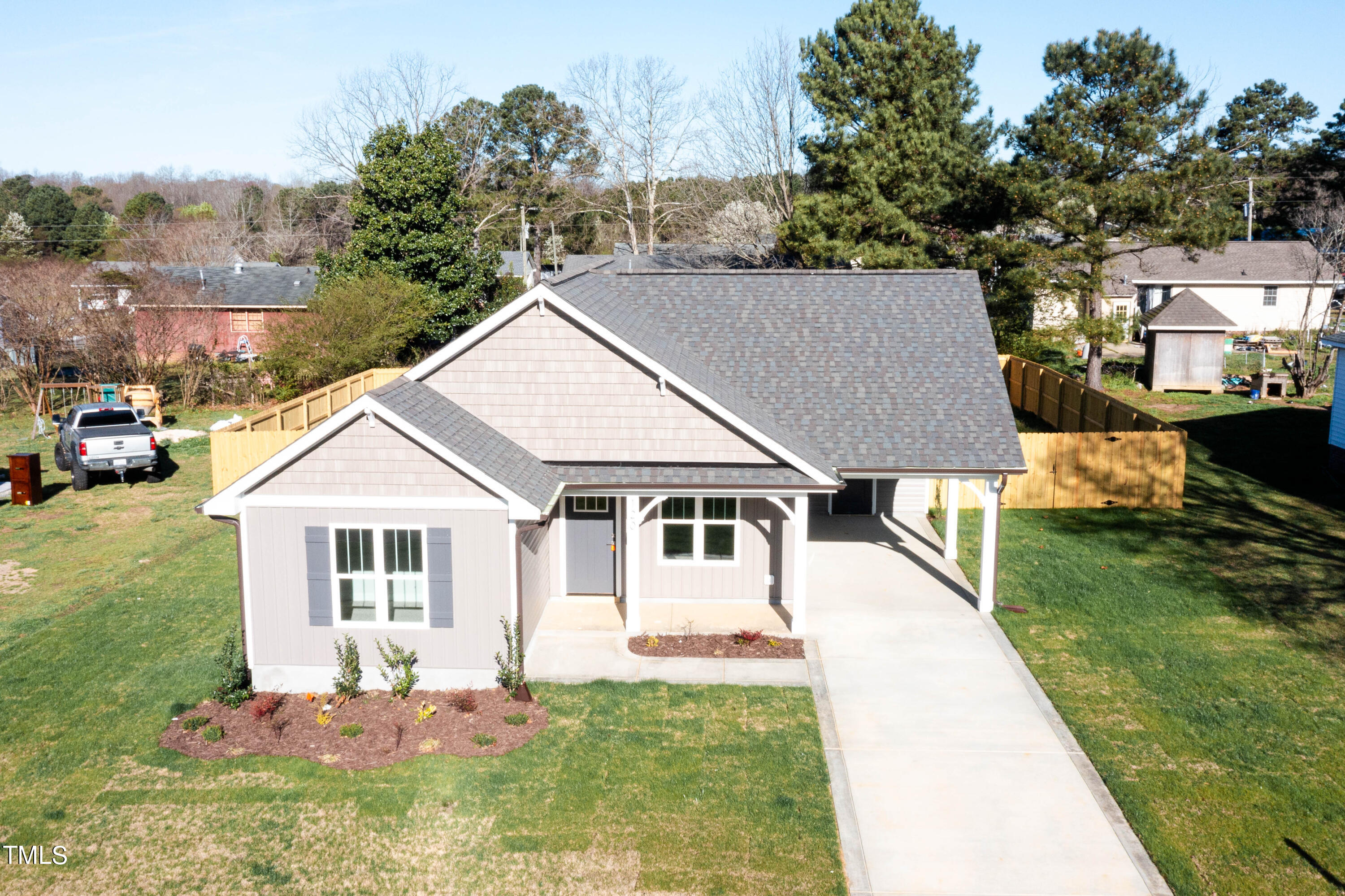 120 Jupiter Drive Dunn, NC 28334 - Photo 36 of 40 a aerial view of a house with a yard table and chairs