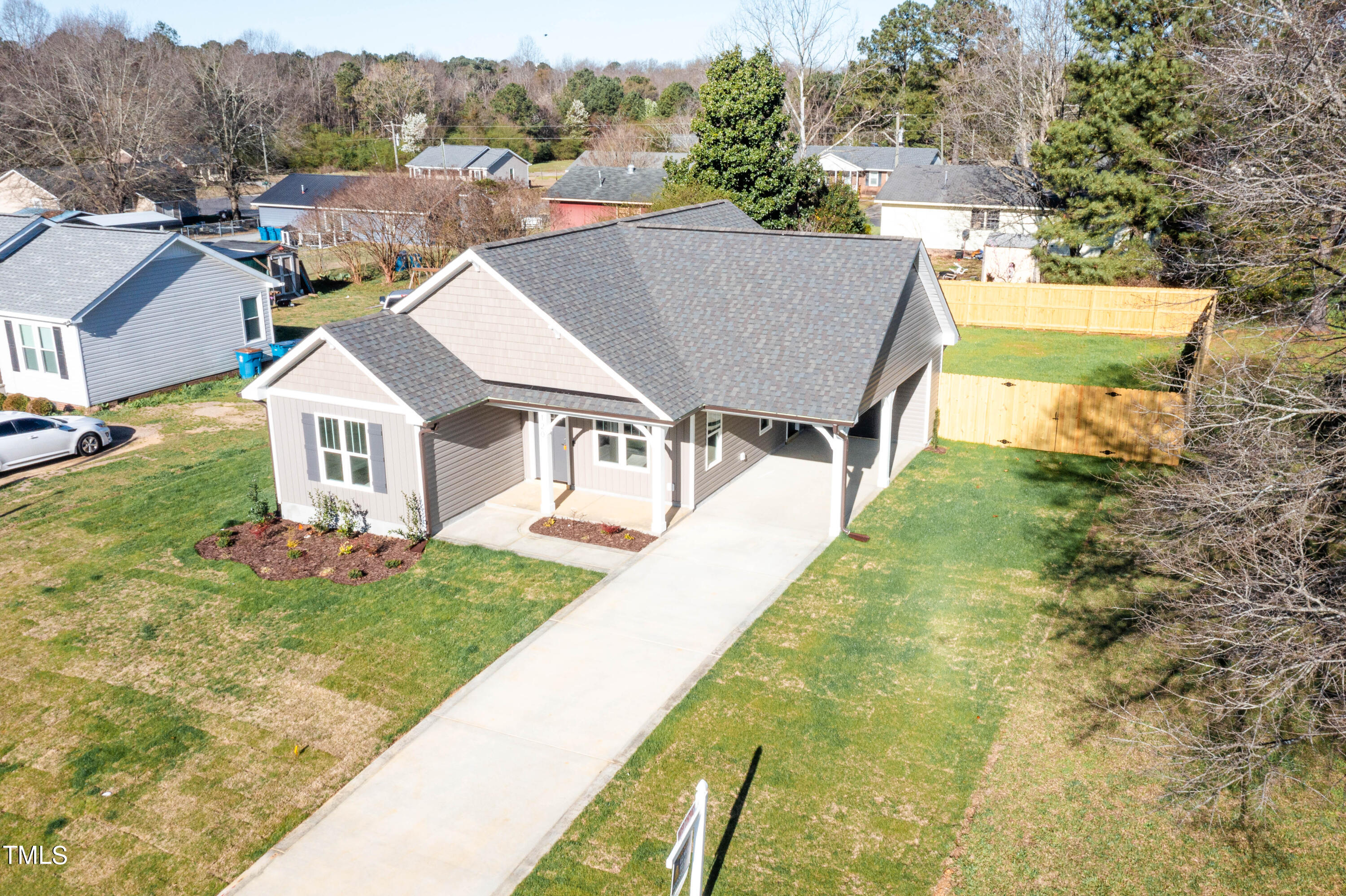 120 Jupiter Drive Dunn, NC 28334 - Photo 38 of 40 a aerial view of a house next to a yard with plants and large trees