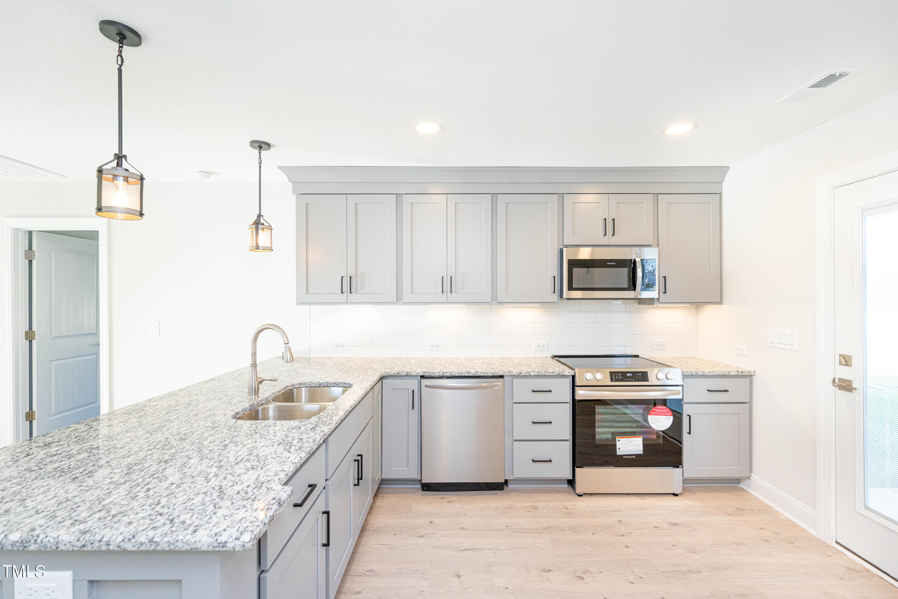 120 Jupiter Drive Dunn, NC 28334 - Photo 5 of 40 a kitchen with stainless steel appliances granite countertop a sink stove and cabinets