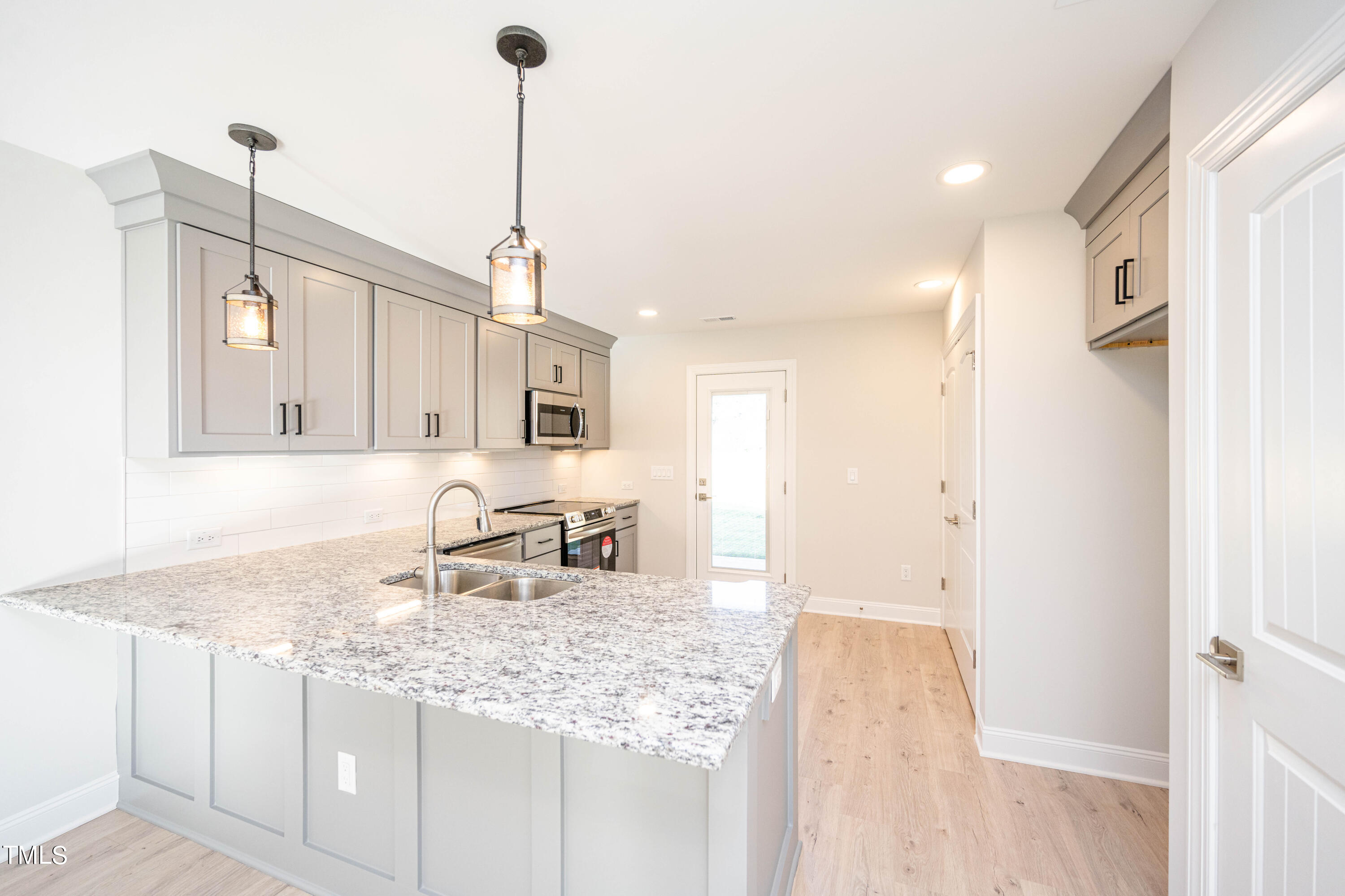 120 Jupiter Drive Dunn, NC 28334 - Photo 7 of 40 a kitchen with granite countertop sink and cabinets