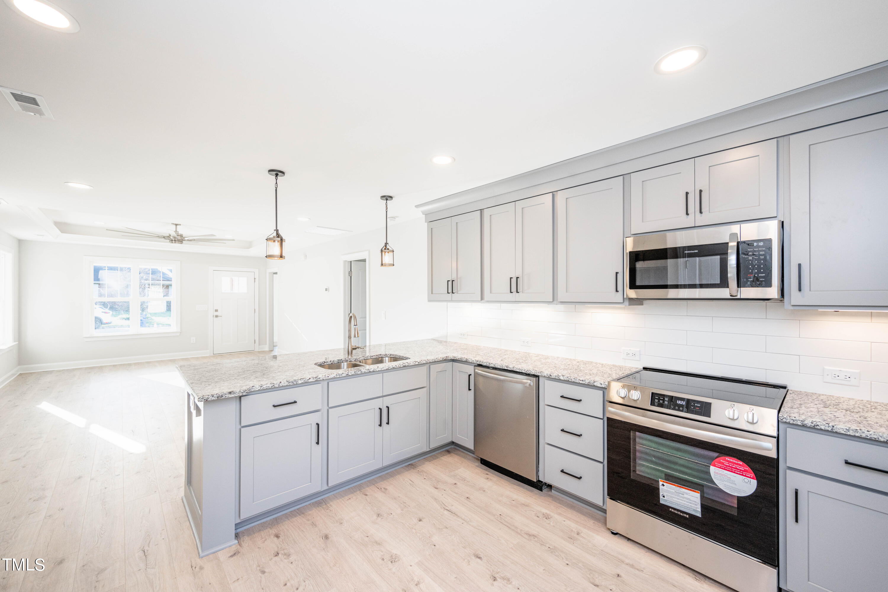 120 Jupiter Drive Dunn, NC 28334 - Photo 8 of 40 a kitchen with stainless steel appliances granite countertop a stove and a sink