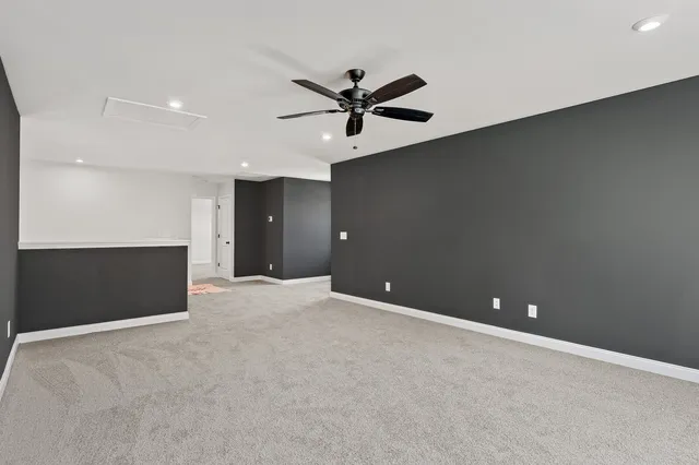 a view of an empty room with a ceiling fan