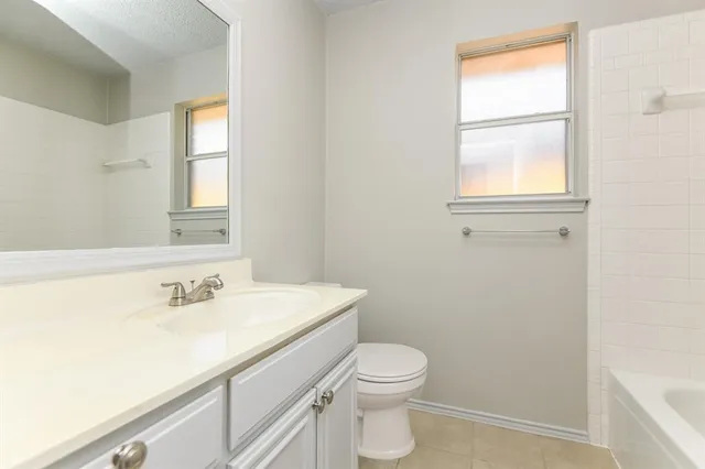 a bathroom with a sink a toilet and window