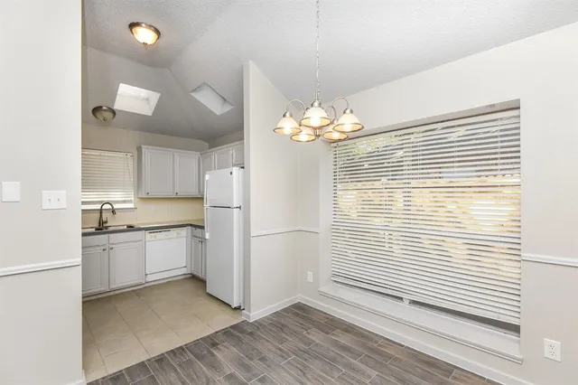 a kitchen with a white cabinets and white appliances