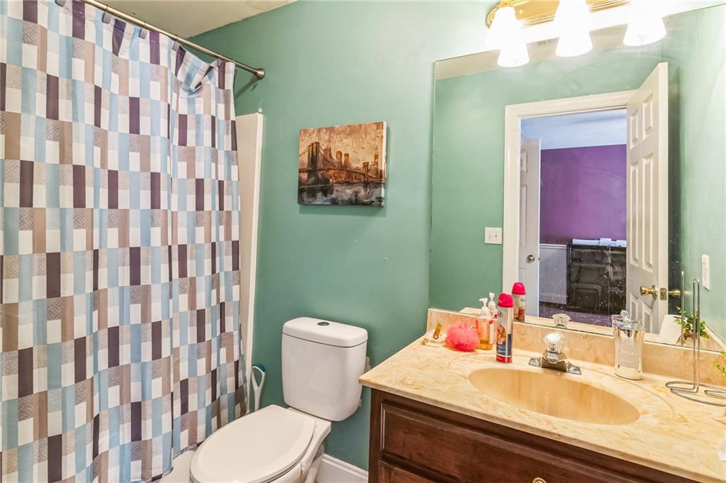 157 Gates Road Lizella, GA 31052 - Photo 12 of 13 a bathroom with a sink a toilet and a mirror