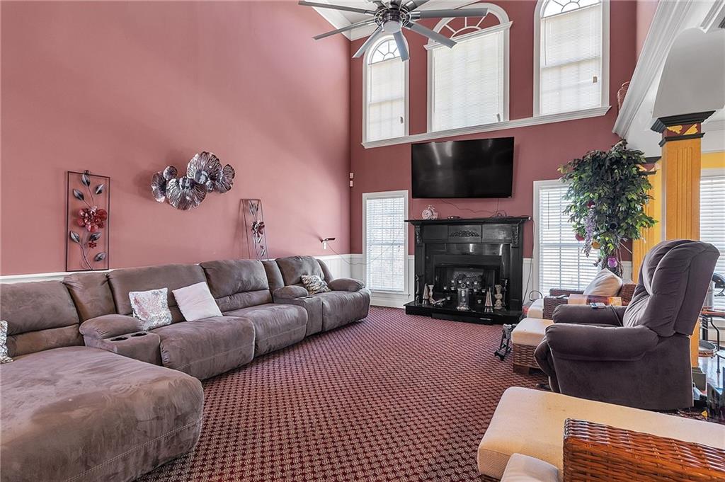 157 Gates Road Lizella, GA 31052 - Photo 3 of 13 a living room with furniture a flat screen tv and a fireplace