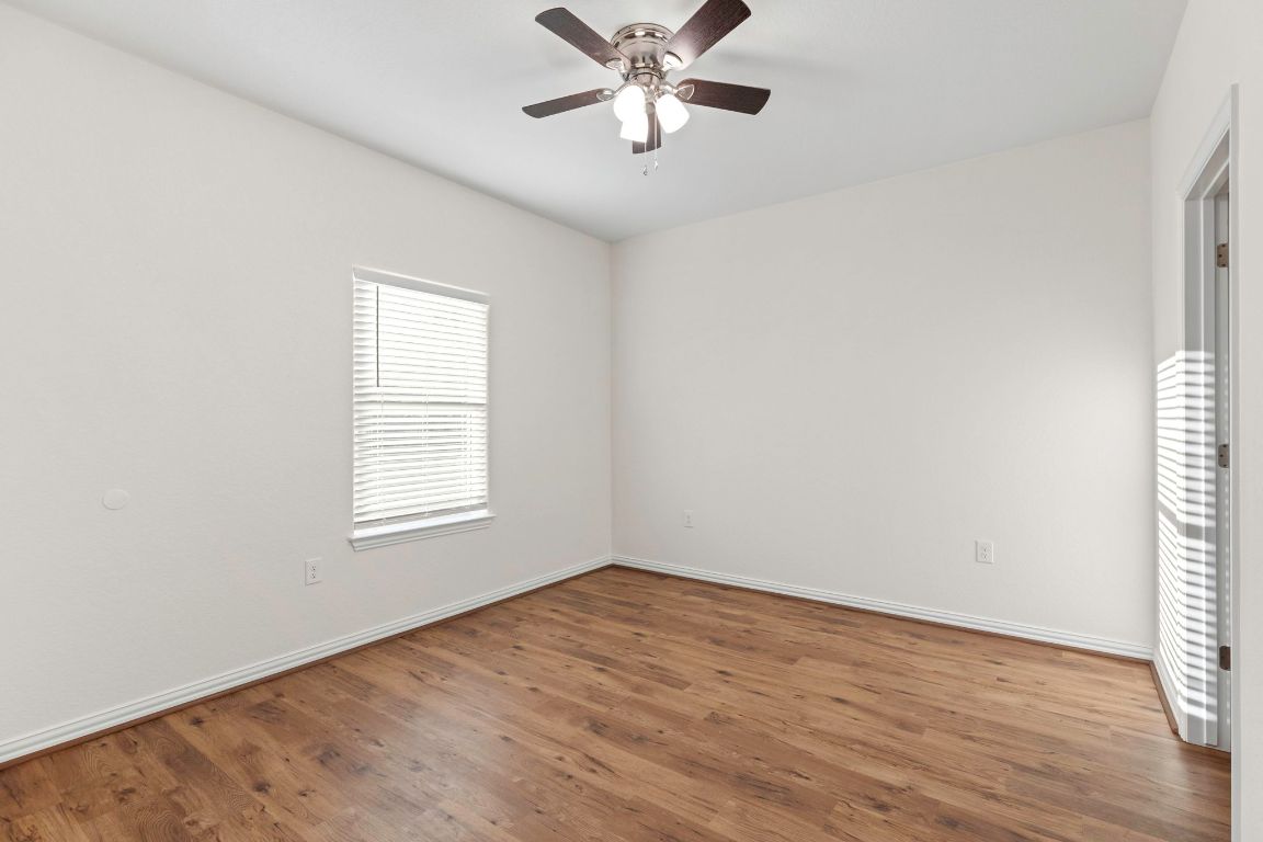 1303 Aransas Street Lockhart, TX 78644 - Photo 12 of 16 an empty room with wooden floor closet and windows