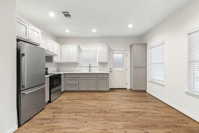 a kitchen with a refrigerator and a sink