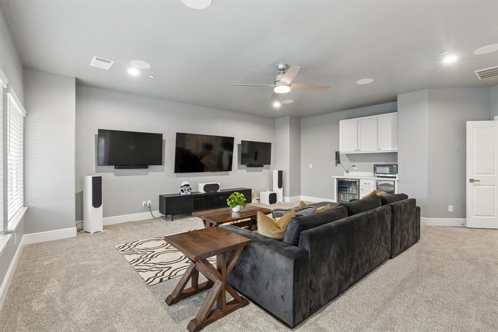 6700 Herbert Road Colleyville, TX 76034 - Photo 20 of 32 a living room with furniture a flat screen tv and kitchen view