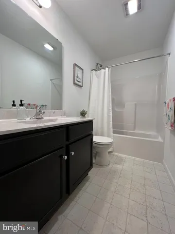 a living room with furniture a flat screen tv and a large window