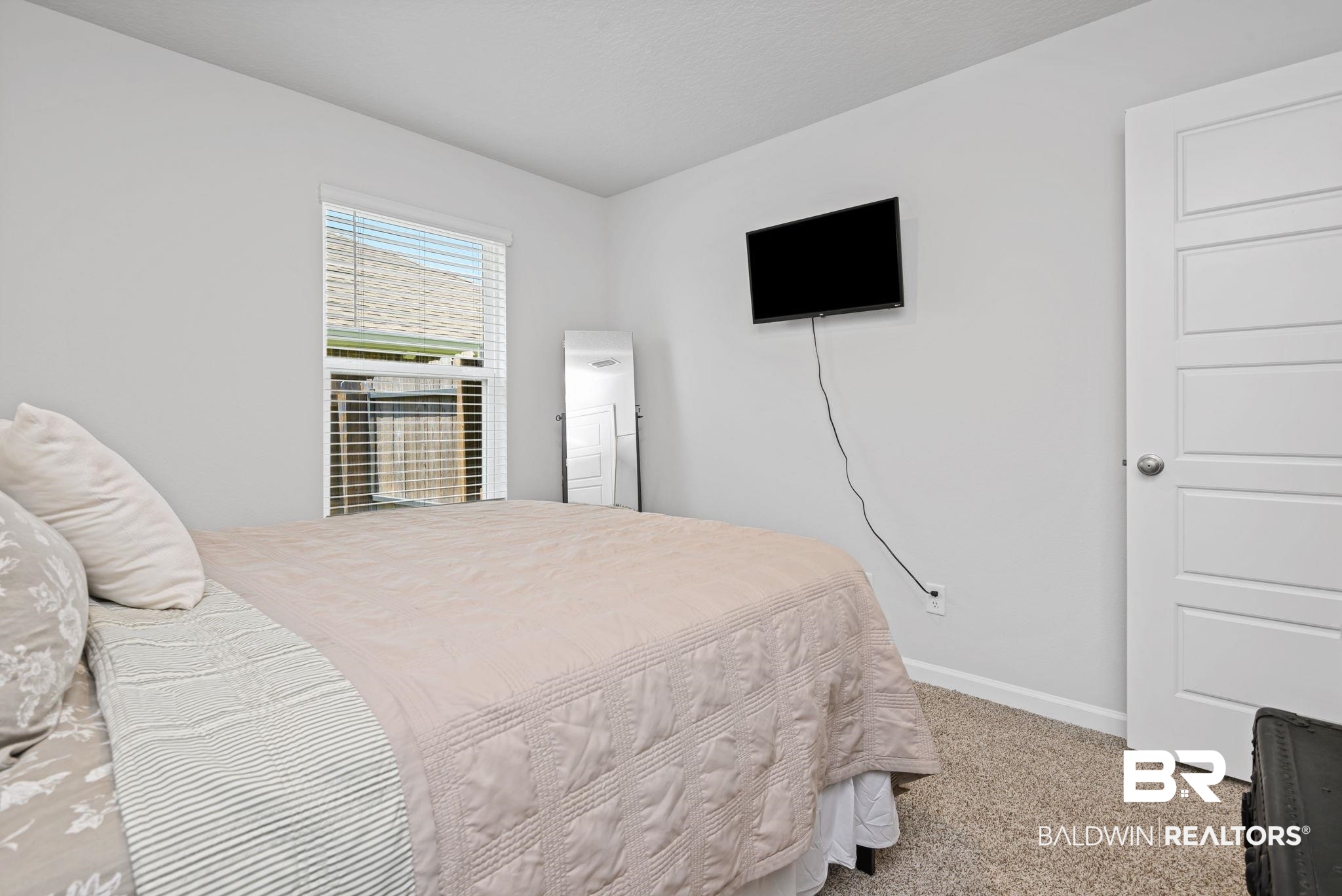 8021 Valor Rdg Way North Mobile, AL 36619 - Photo 13 of 34 Carpeted room with a window featuring blinds, light gray walls, and a white paneled door