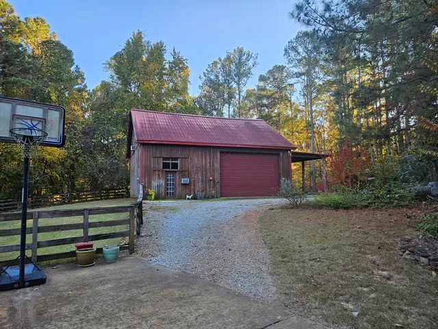 a view of a house with a yard and tree s