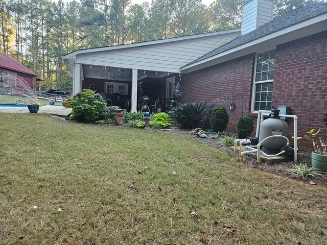 a view of a house with backyard and porch
