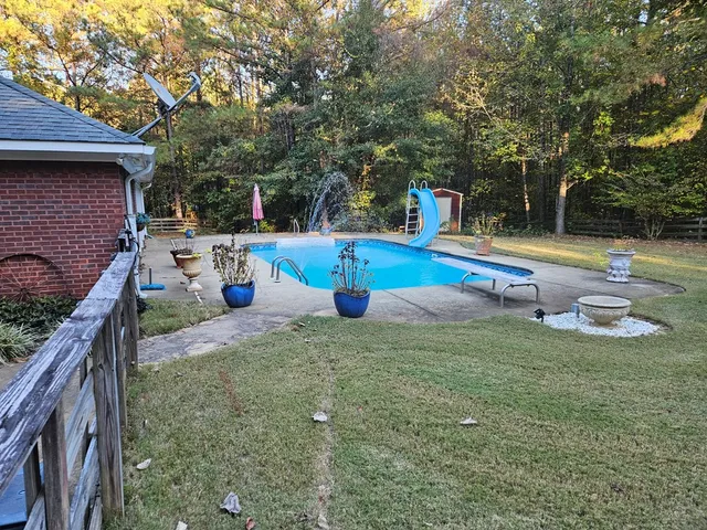 a view of a swimming pool with a patio