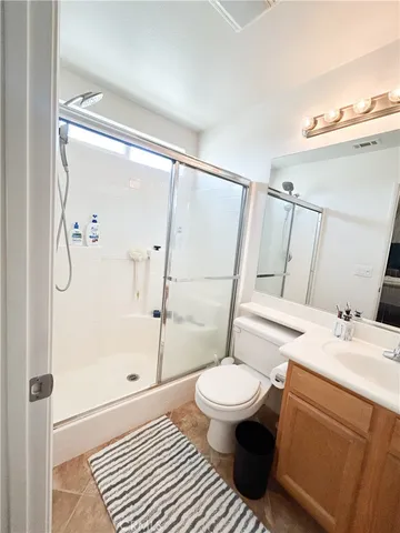a living room with furniture a rug and white walls