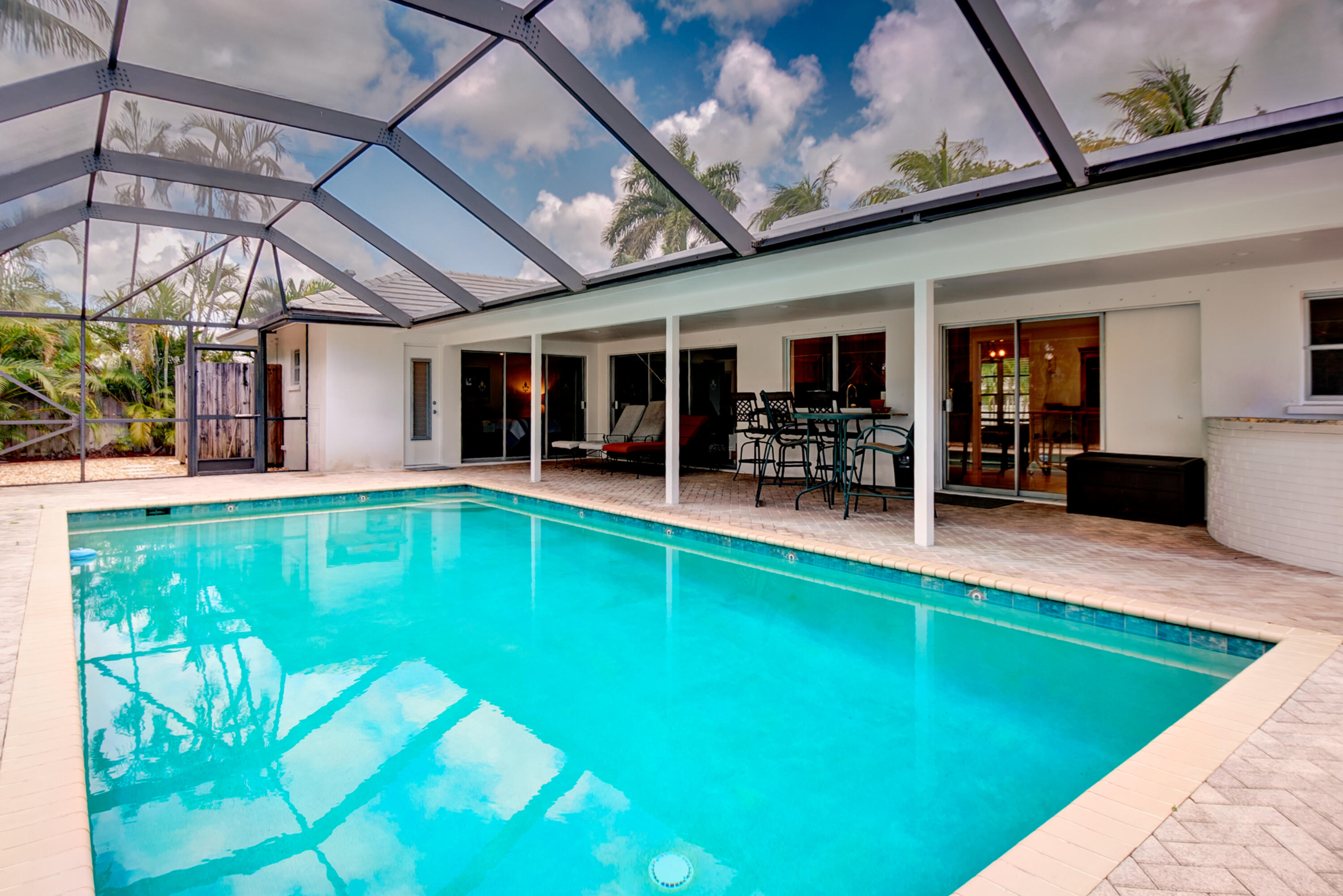 1348 Southwest 4th Street Boca Raton, FL 33486 - Photo 24 of 44 a view of a swimming pool with a patio