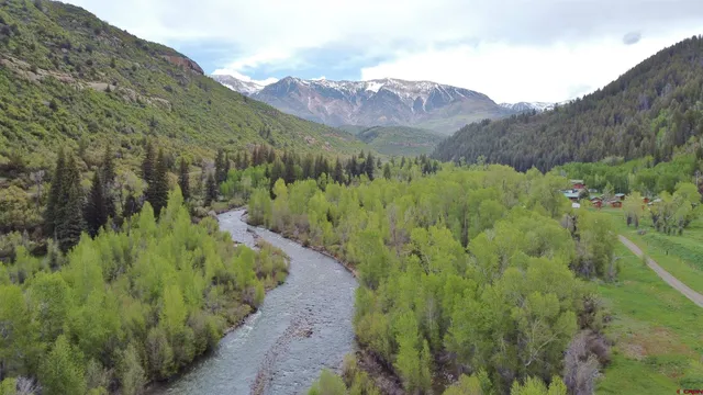 a view of a lush green hillside and houses