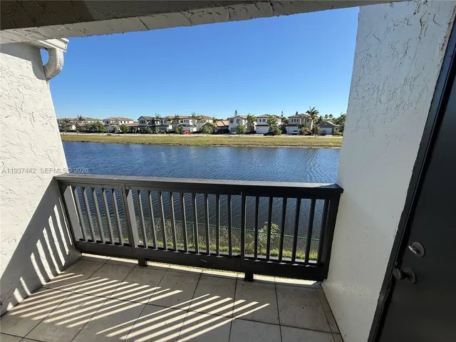 a view of balcony with wooden floor and a ocean view