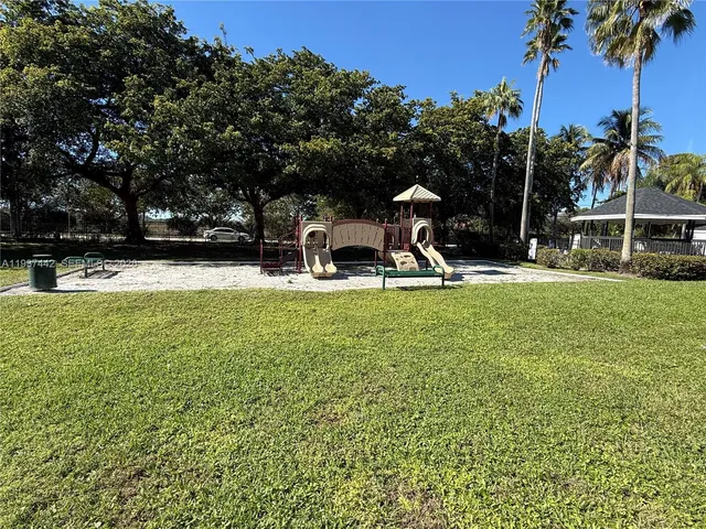 a view of a park with swings and slides