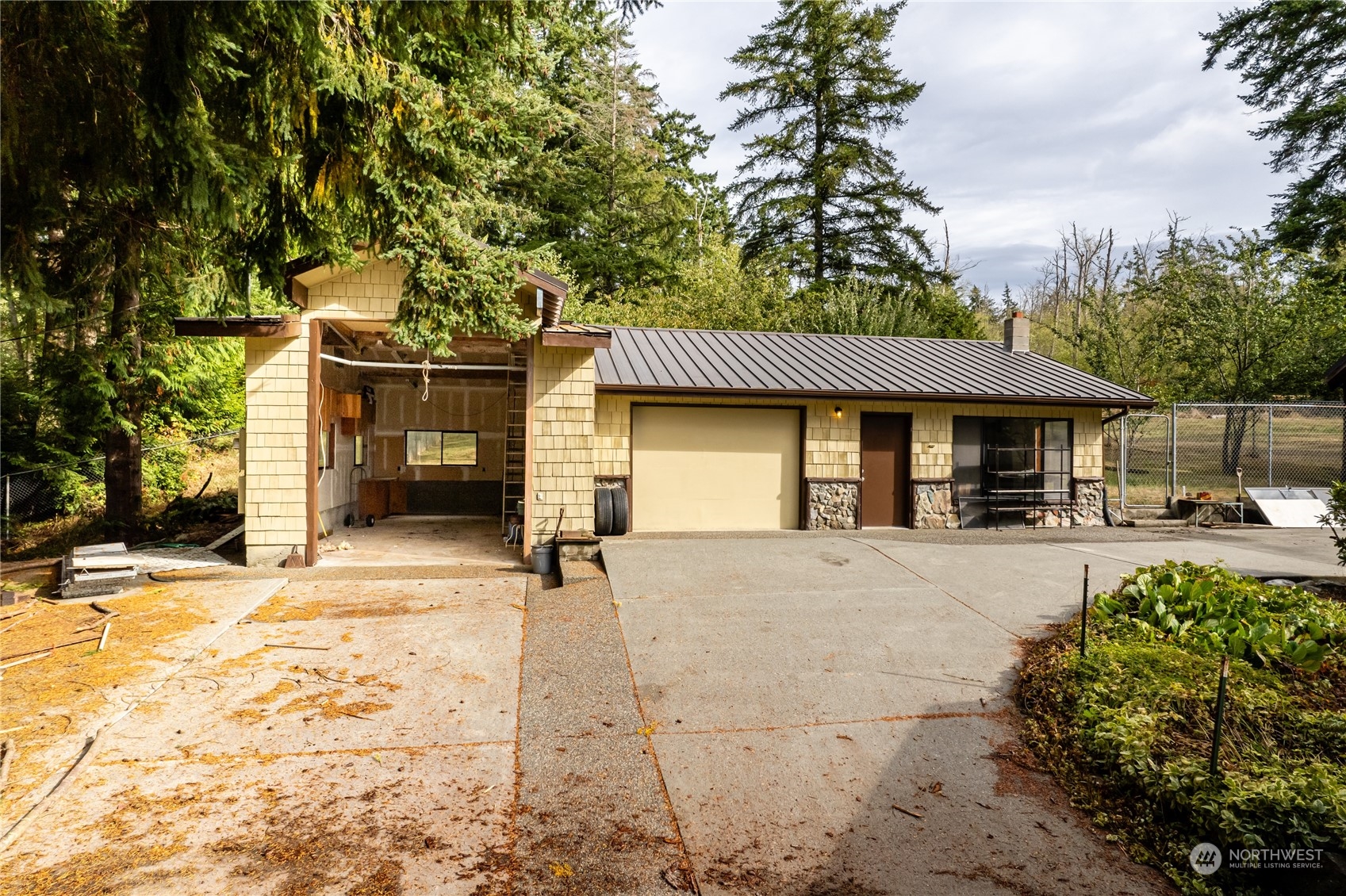 5443 Emil Road Langley, WA 98260 - Photo 4 of 37 a front view of a house with a yard and garage