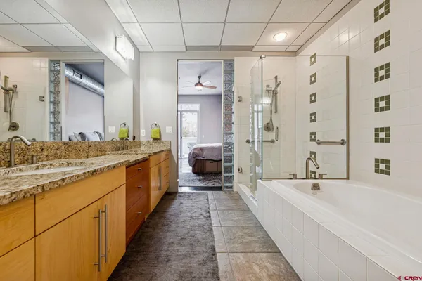 a living room with lots of furniture and a potted plant