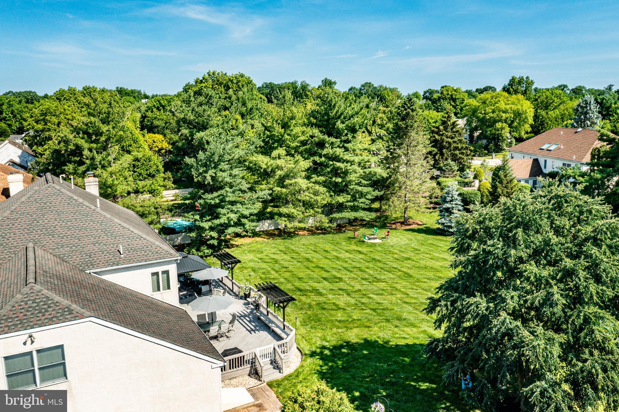 1716 St Georges Road Dresher, PA 19025 - Photo 23 of 90 Lush greenery surrounds a serene backyard oasis.