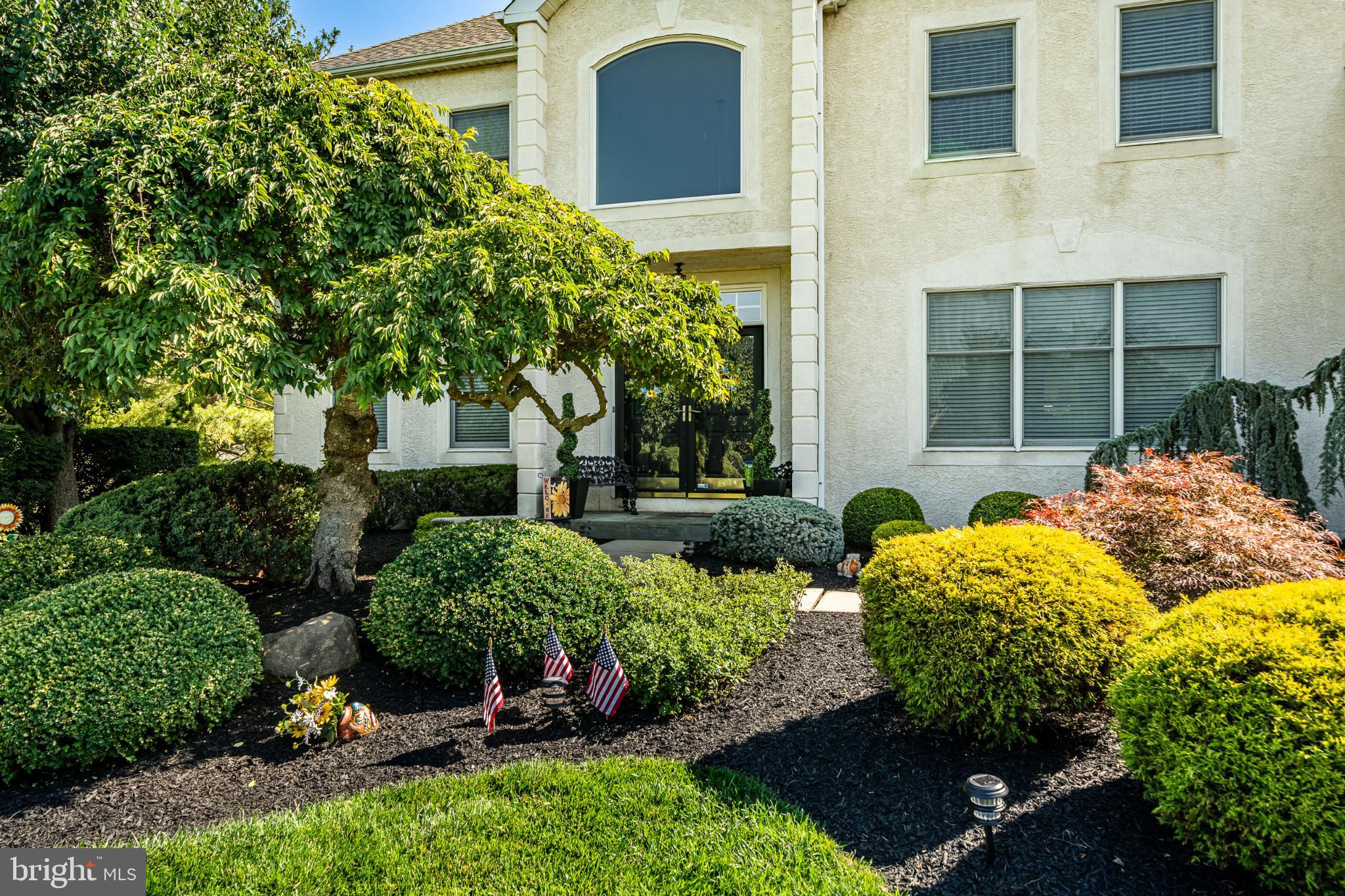 1716 St Georges Road Dresher, PA 19025 - Photo 7 of 90 Lush landscaping frames a welcoming entrance.