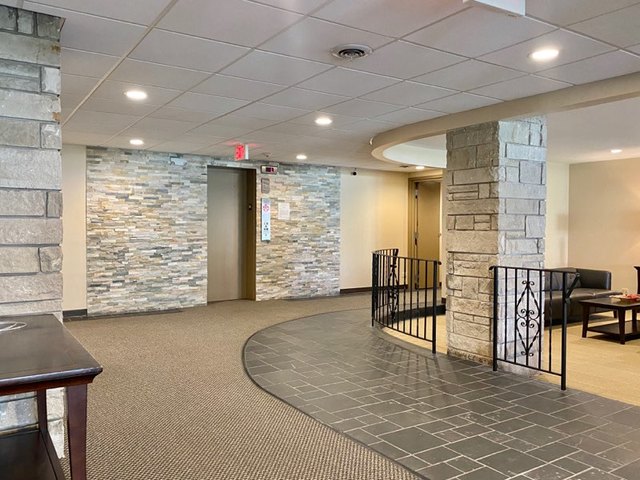 2400 Windsor Mall, Unit 1K Park Ridge, IL 60068 - Photo 8 of 13 an empty room with wooden floor and windows