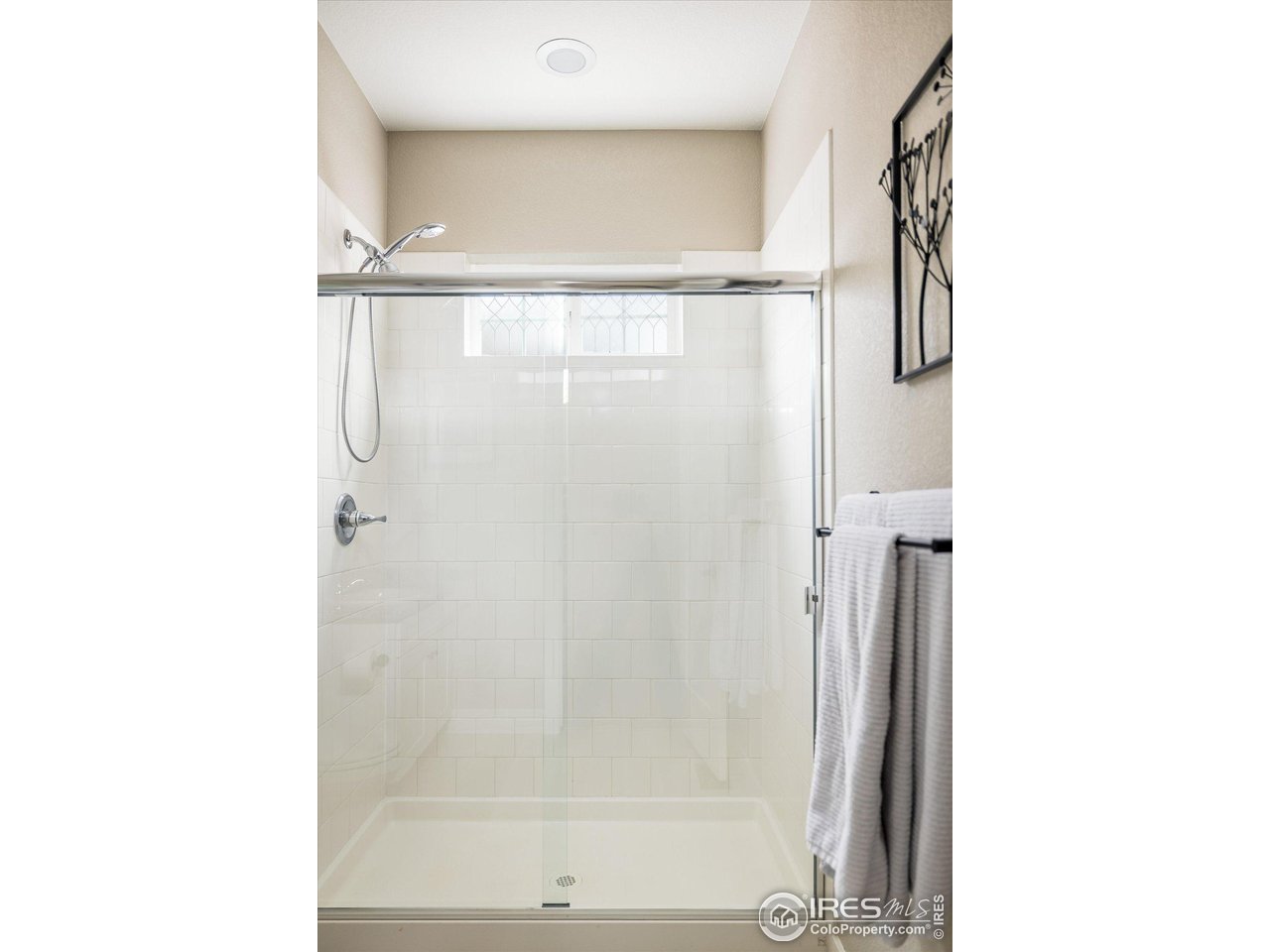 10121 Flower Street Westminster, CO 80021 - Photo 18 of 40 easily accessible main-level 3/4 bath with modern shower