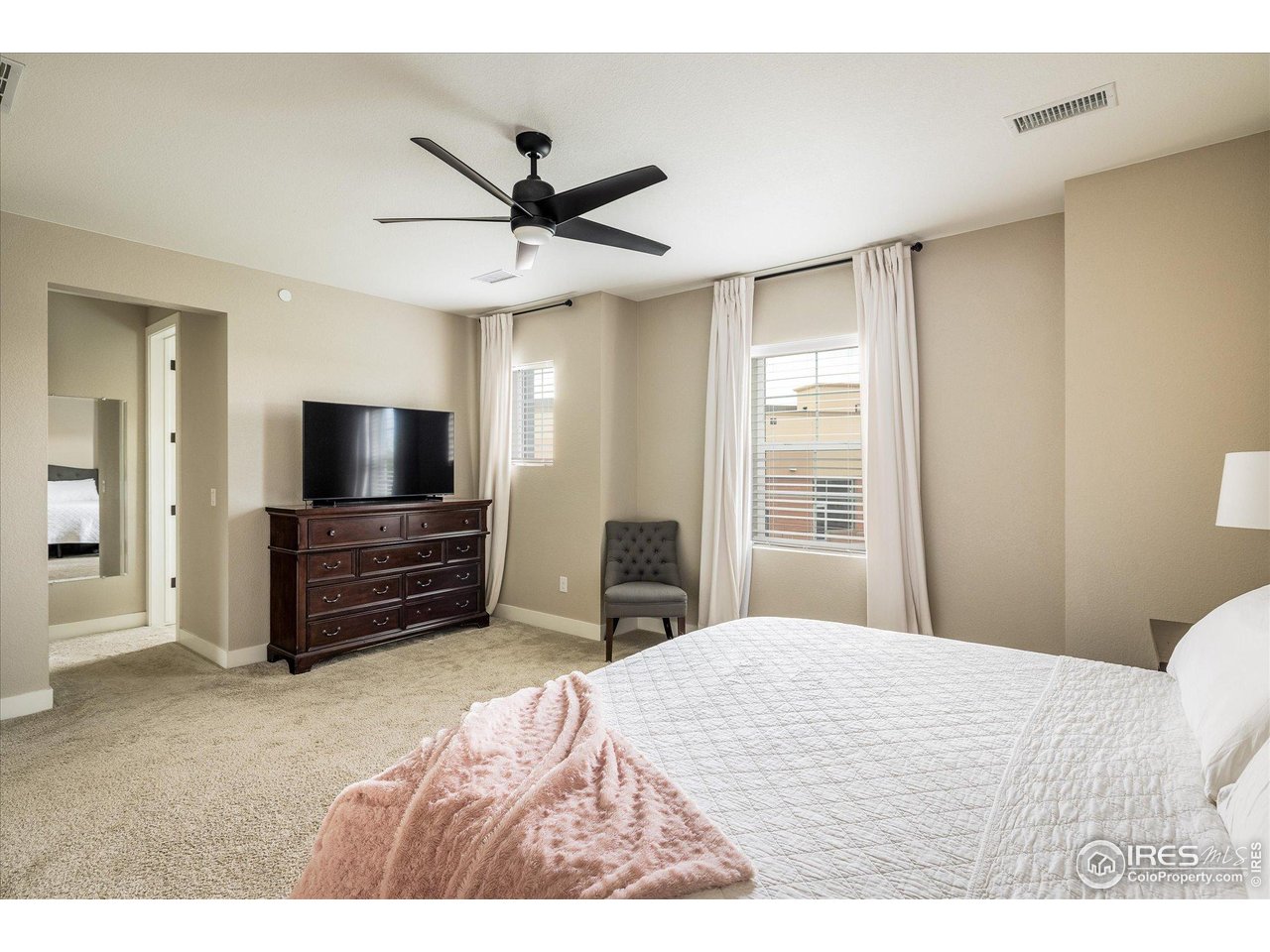 10121 Flower Street Westminster, CO 80021 - Photo 20 of 40 serene primary suite boasts a walk-in closet and an en-suite bath