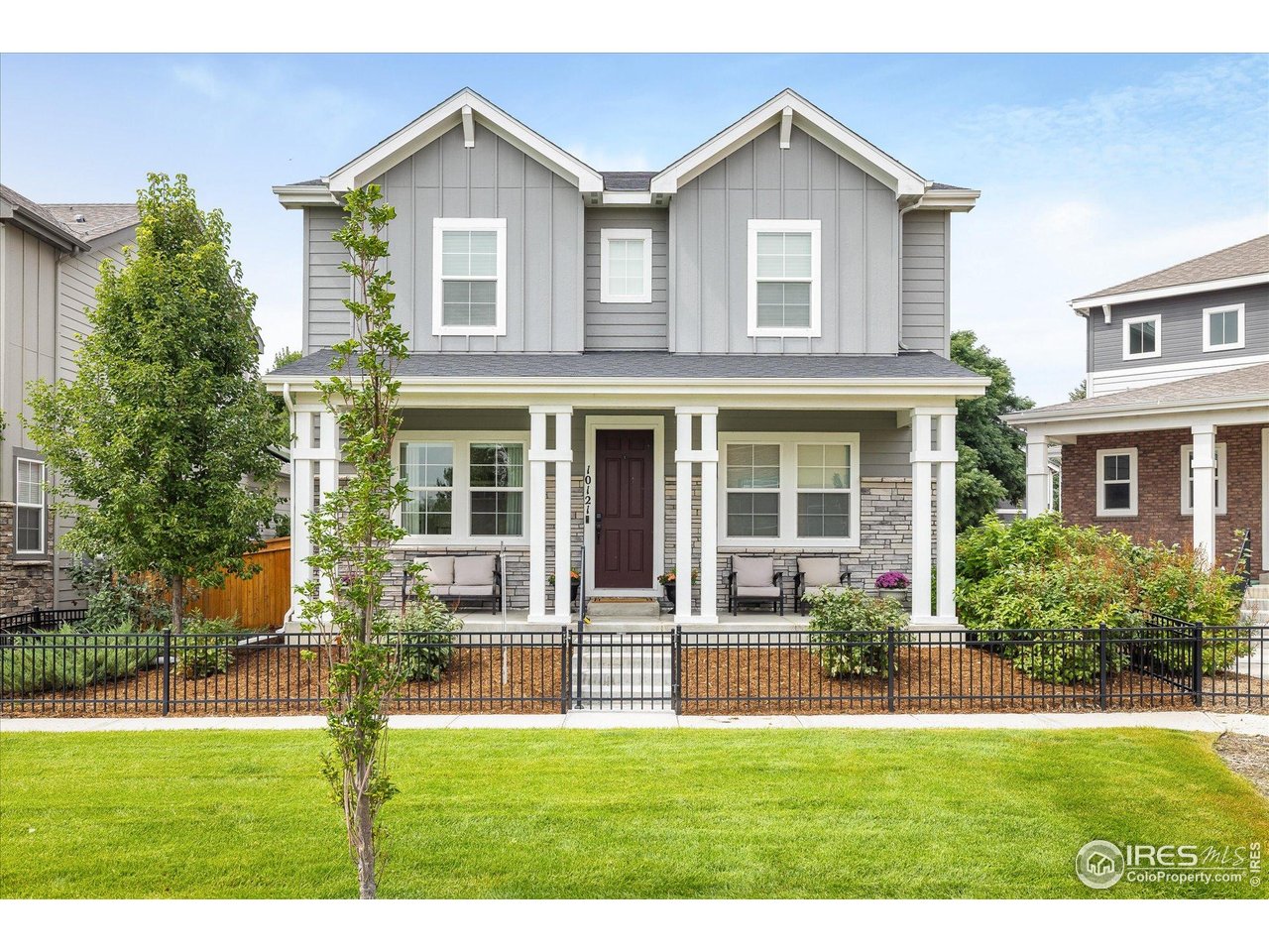 10121 Flower Street Westminster, CO 80021 - Photo 2 of 40 beautifully landscaped community green space directly in front of the home with walking paths and manicured beds
