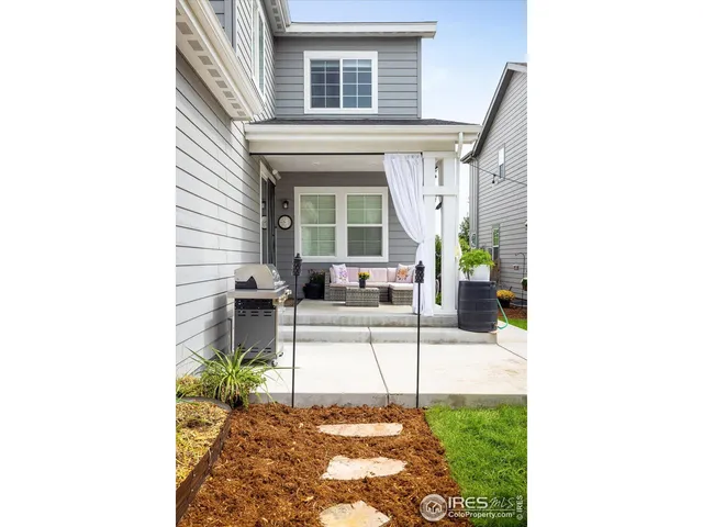 a living room with a large window and furniture
