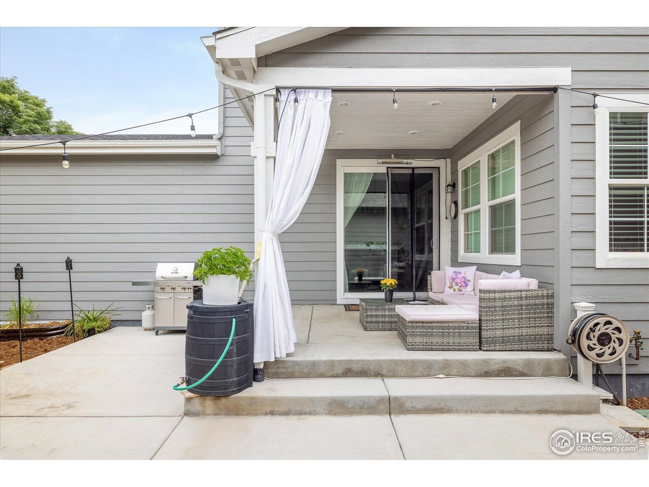 10121 Flower Street Westminster, CO 80021 - Photo 36 of 40 extended concrete patio under cover with caf lights-ideal for dining and lounging with direct yard access