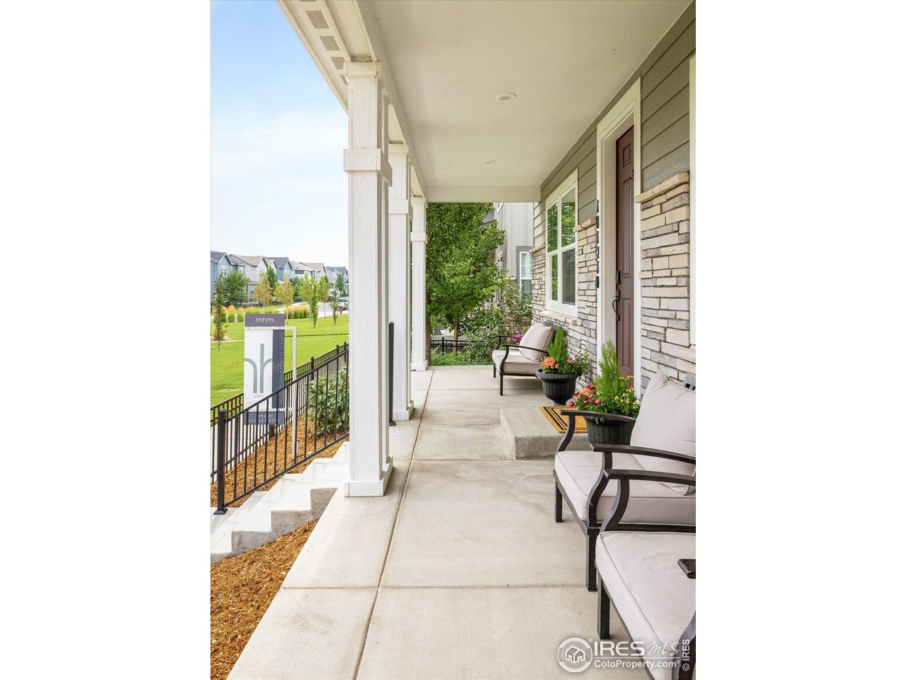 10121 Flower Street Westminster, CO 80021 - Photo 5 of 40 extended porch walkway with easy access to the front gate and low-maintenance landscaping