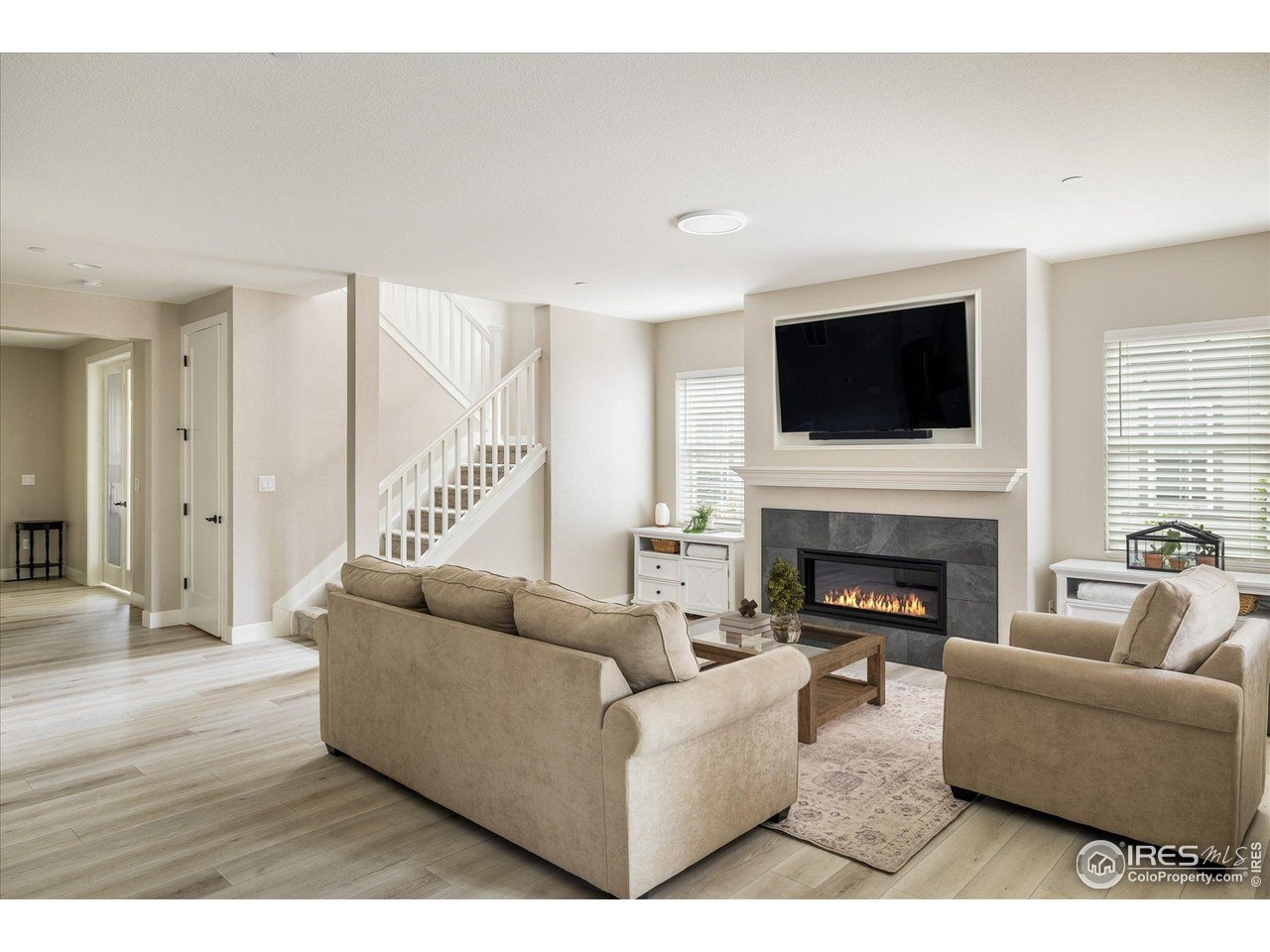 10121 Flower Street Westminster, CO 80021 - Photo 9 of 40 this inviting open-concept living room showcases expansive windows that fill the space with light