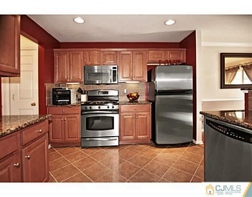36 Raritan Reach Road South Amboy, NJ 08879 - Photo 9 of 22 a kitchen with granite countertop a refrigerator stove and microwave