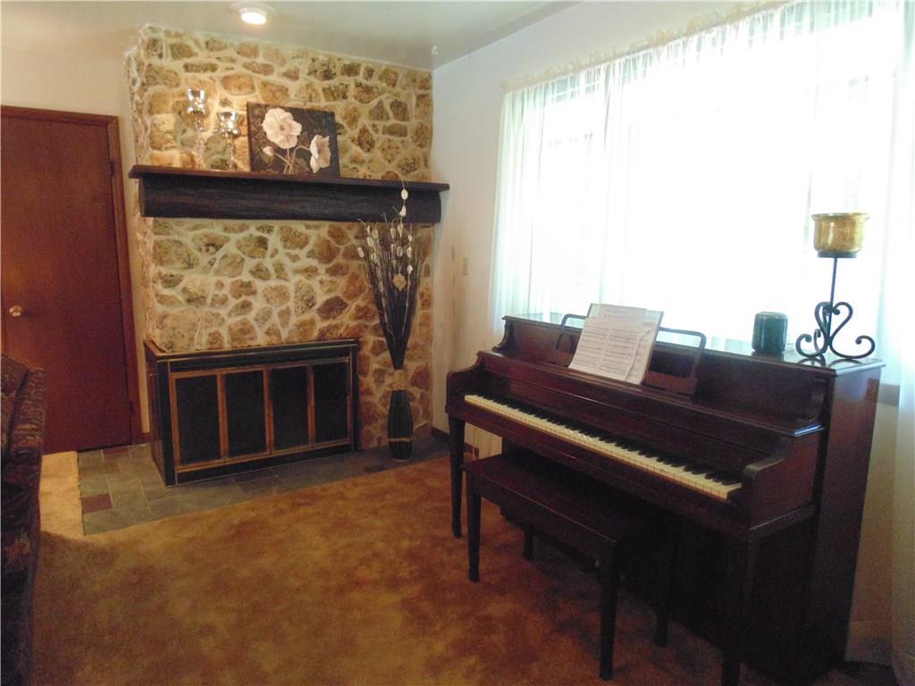 138 Reiber Road Renfrew, PA 16053 - Photo 7 of 20 The corner, stone fireplace adds warmth to the room, and can be a focal point for several different furnishing options.