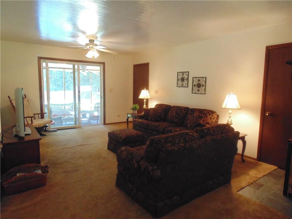138 Reiber Road Renfrew, PA 16053 - Photo 8 of 20 The living/dining area leads to a screened-in sunporch overlooking the fenced-in, in-ground pool.
