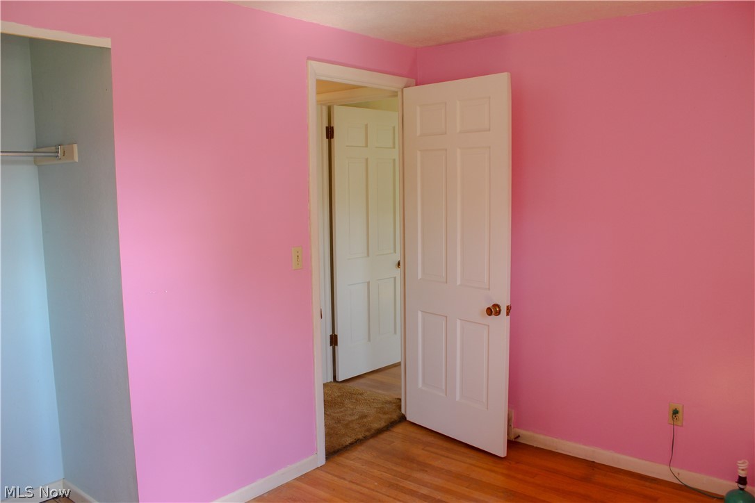 11910 West Lake Road Vermilion, OH 44089 - Photo 16 of 28 Bedroom with natural hardwood flooring and a healthy amount of sunlight