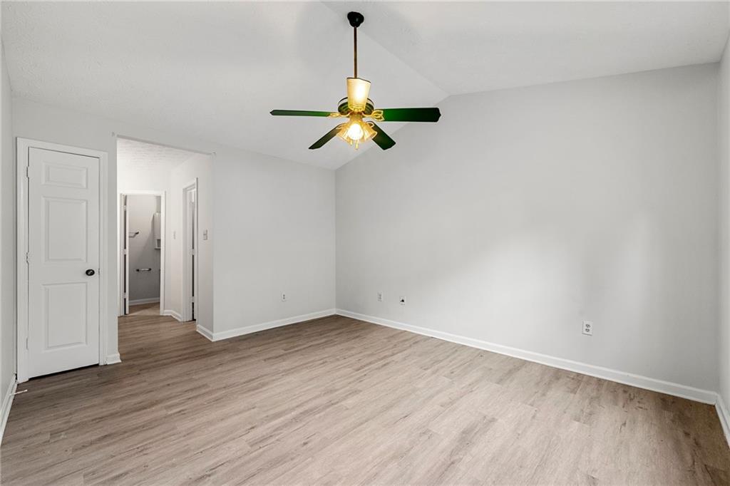 2575 Picardy Circle North, Unit B Atlanta, GA 30349 - Photo 11 of 20 a a room with wooden floor ceiling fan and window