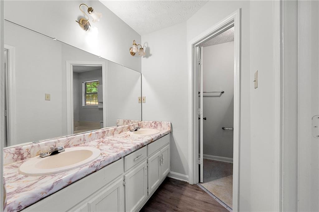 2575 Picardy Circle North, Unit B Atlanta, GA 30349 - Photo 12 of 20 a spacious bathroom with a double vanity sink and a mirror
