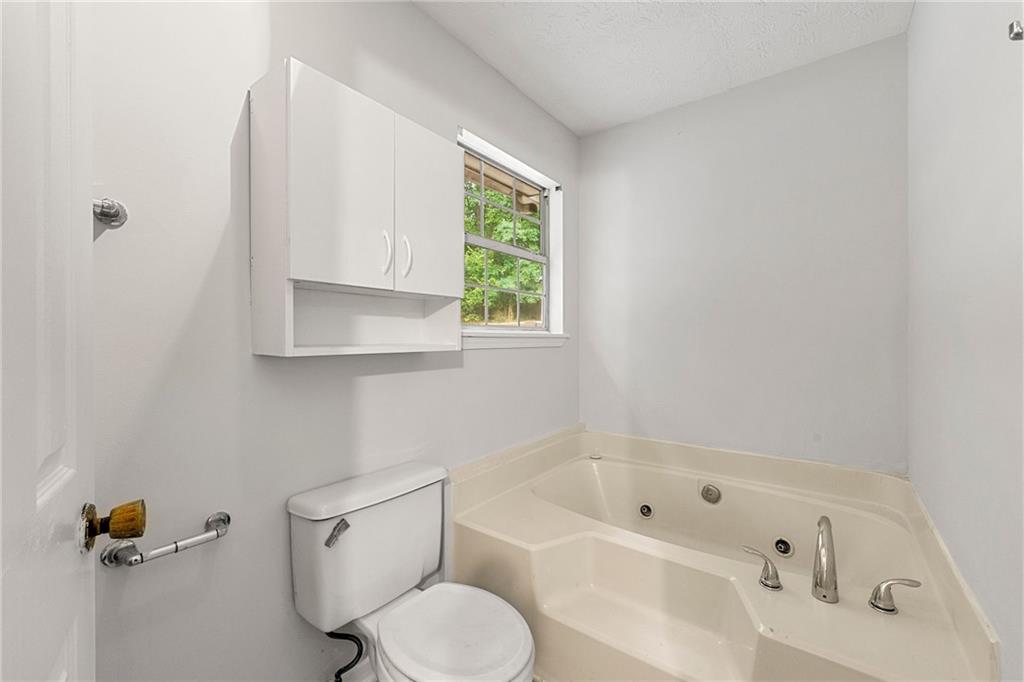 2575 Picardy Circle North, Unit B Atlanta, GA 30349 - Photo 13 of 20 a bathroom with a bathtub shower