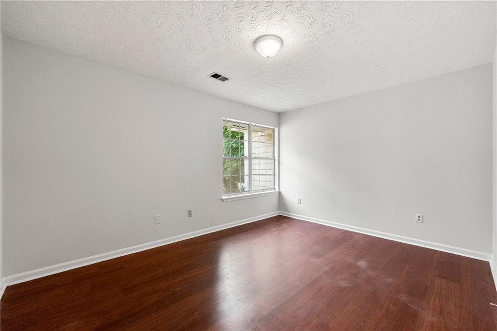 2575 Picardy Circle North, Unit B Atlanta, GA 30349 - Photo 15 of 20 an empty room with wooden floor and window