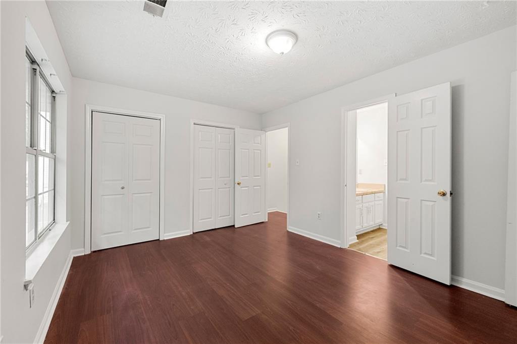 2575 Picardy Circle North, Unit B Atlanta, GA 30349 - Photo 16 of 20 an empty room with wooden floor & windows