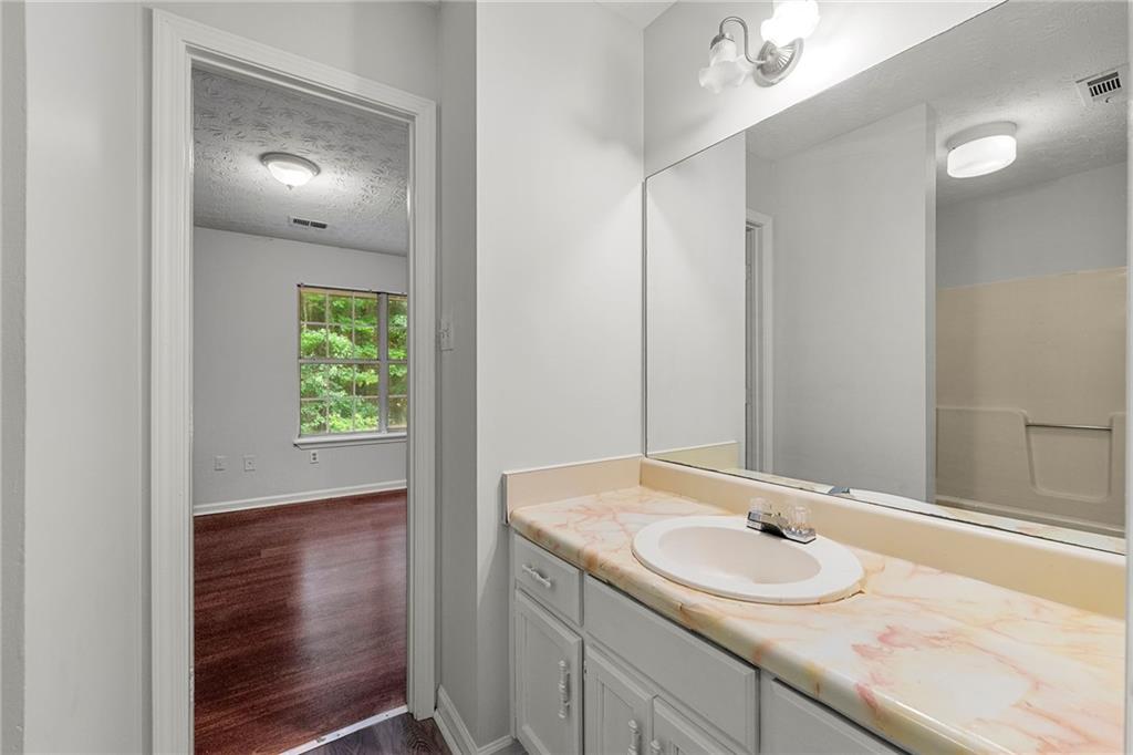2575 Picardy Circle North, Unit B Atlanta, GA 30349 - Photo 17 of 20 a bathroom with a sink and a mirror
