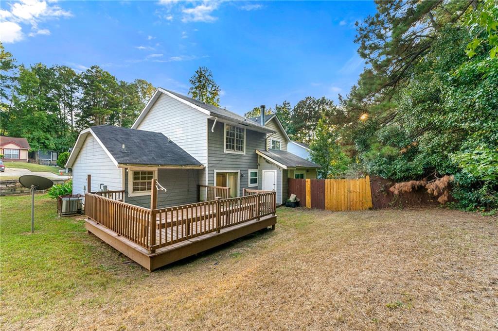 2575 Picardy Circle North, Unit B Atlanta, GA 30349 - Photo 19 of 20 a view of a house with a yard and deck