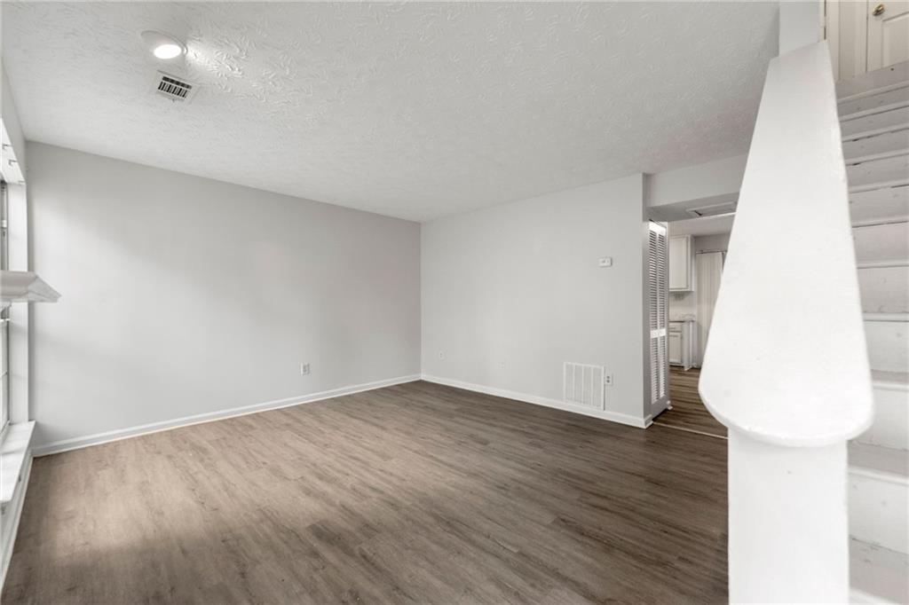 2575 Picardy Circle North, Unit B Atlanta, GA 30349 - Photo 3 of 20 an empty room with wooden floor and glass door