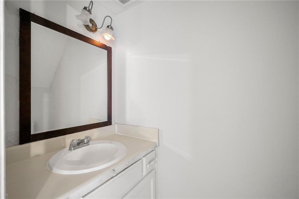 2575 Picardy Circle North, Unit B Atlanta, GA 30349 - Photo 5 of 20 a bathroom with a sink and a mirror